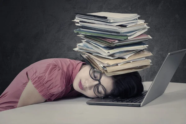 Stressful woman with paperwork on her head — Stock Photo, Image