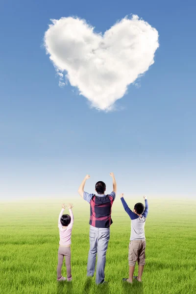 Happy father and kids with heart symbol Stock Image