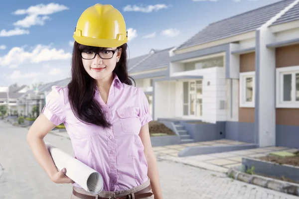 Young developer with blueprint at residential site — Stock Photo, Image