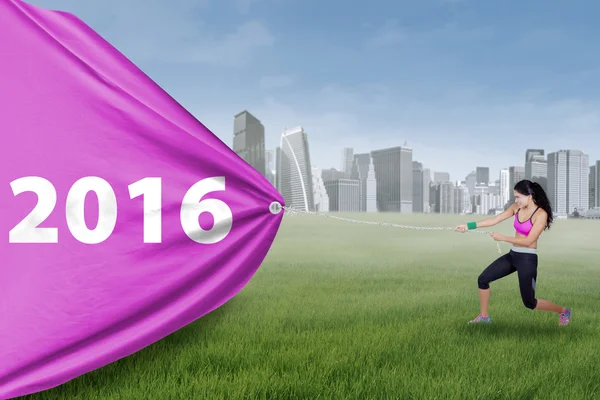 Indian woman pulls numbers 2016 at field — Stock Photo, Image