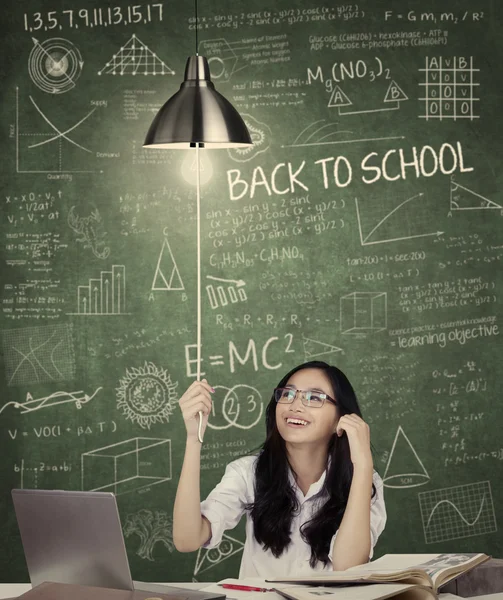 Student turn on a lightbulb in class — Stock Photo, Image