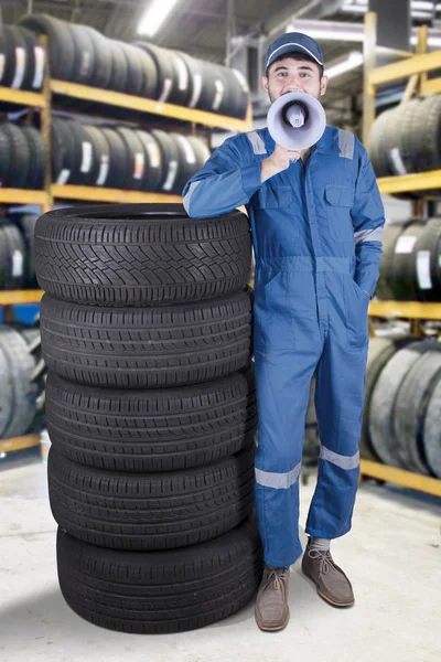 Arabian mechanic with megaphone in workshop — Stock Photo, Image