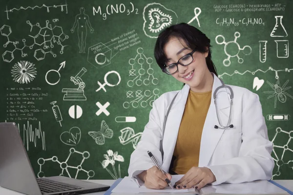 Médecin travaillant avec un document et un carnet — Photo