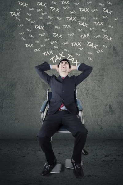 Handicapped businessman thinking his tax — Stock Photo, Image