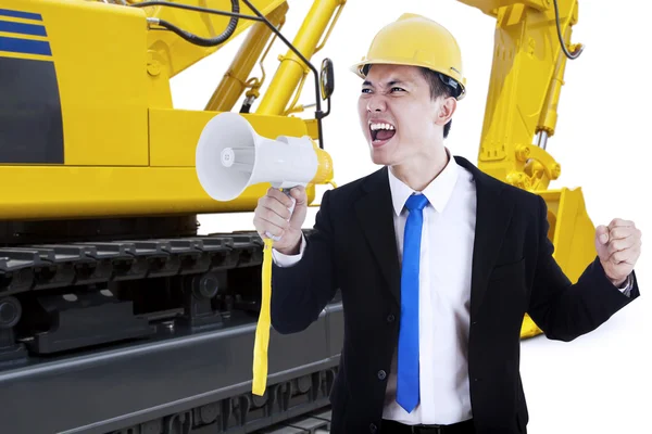 Male contractor with megaphone and excavator — Stock Photo, Image