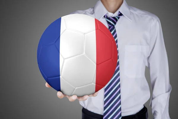 Homme d'affaires montre une balle avec le drapeau de la France — Photo