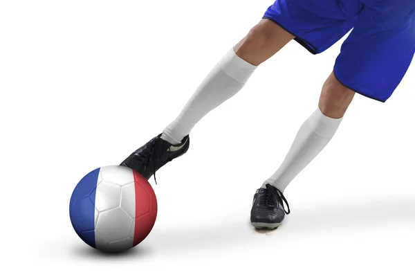 Foot of football player kicks a ball — Stock Photo, Image