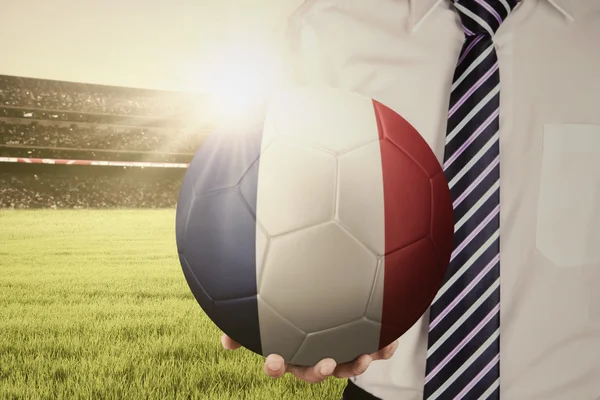 Businessperson holds ball in stadium — Stock Photo, Image