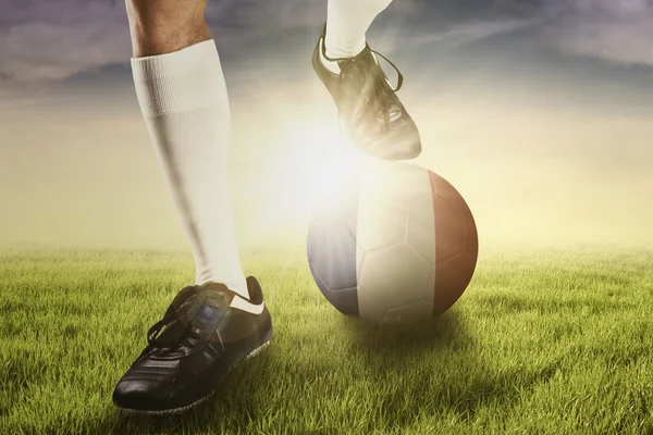 Foot of soccer player with ball and flag of France — Stock Photo, Image