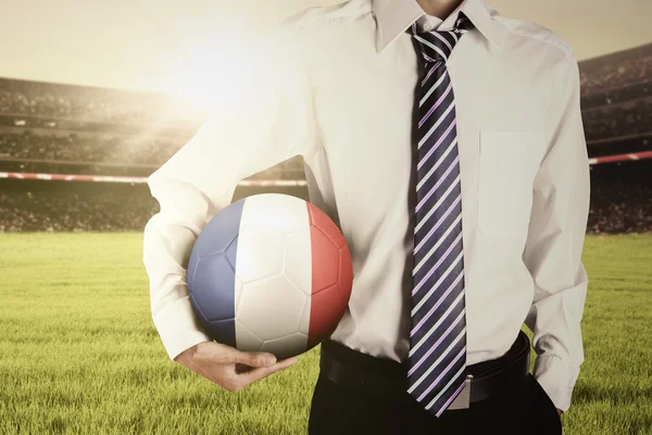 Man with formal suit holds ball at field — Stock Photo, Image