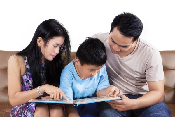 Eltern und ihr Sohn lesen ein Märchenbuch — Stockfoto