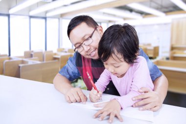 Genç adam yazmak için küçük kız öğretir