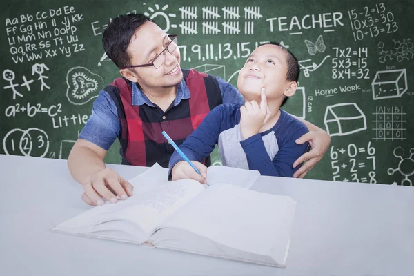 Male teacher teaches a little boy