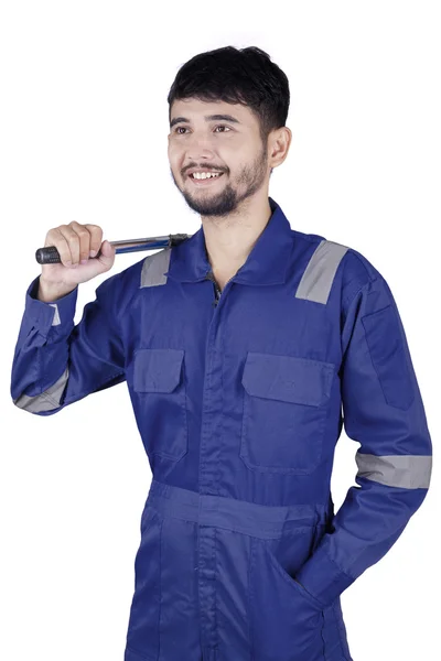 Mechanic with a tool and wearing uniform — Stock Photo, Image