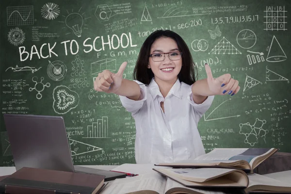 Female student showing thumbs up — Stock Photo, Image