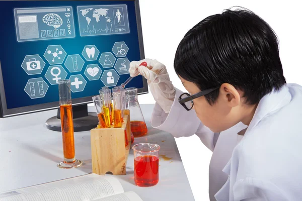 Boy makes experiments with monitor on desk — Stock Photo, Image