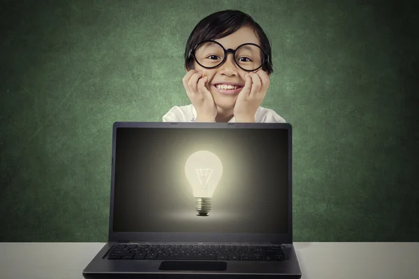 Barn med glödlampa på laptop skärm — Stockfoto