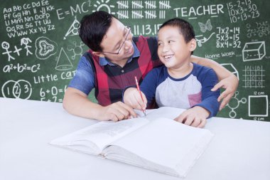 Öğretmen öğrenmek için küçük bir çocuk yardımcı olur.