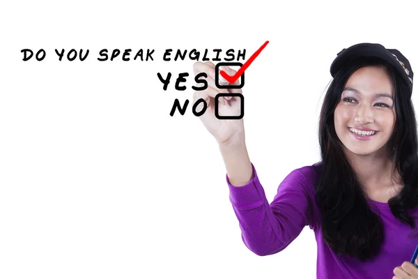 Beautiful schoolgirl writing English — Stock Photo, Image