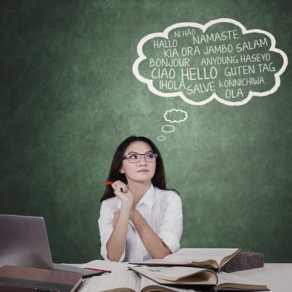 Pretty schoolgirl learns foreign language — Stock Photo, Image