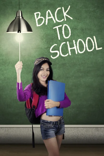 Student turn on light bulb in class — Stock Photo, Image