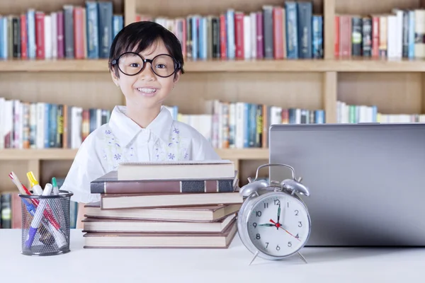 Schoolmeisje met laptop en wetenschap boeken — Stockfoto