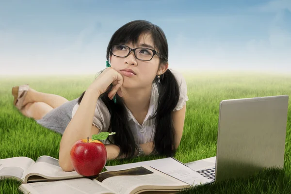 Beautiful student daydreaming on meadow — Stock Photo, Image