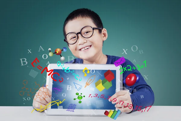 Cute boy holds tablet for studying — Stock Photo, Image