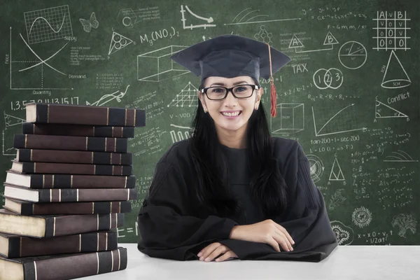 Female bachelor and books in class 1 — Stock Photo, Image