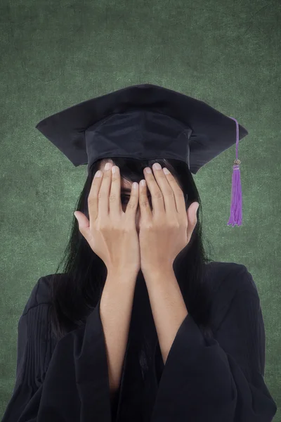 Female student with graduation gown in class — Stock Photo, Image