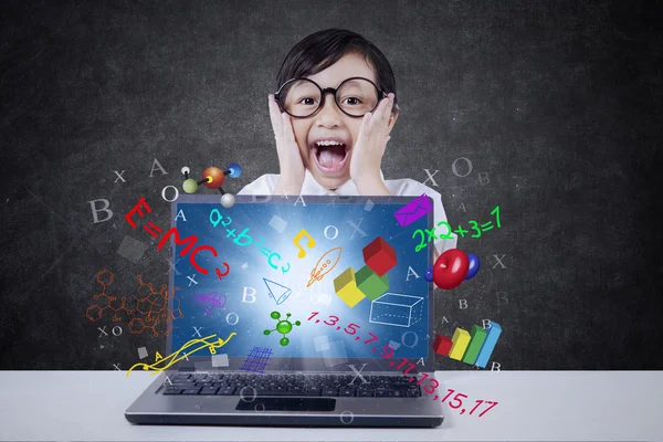 Joyful student with laptop and formula — Stock Photo, Image