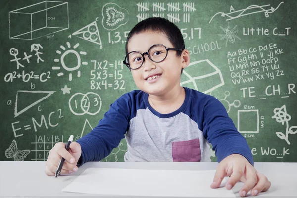 Sınıfta okuyan gözlüklü küçük çocuk Telifsiz Stok Imajlar