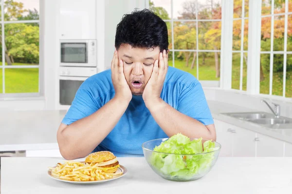Asian person confused to choose food — Stock Photo, Image