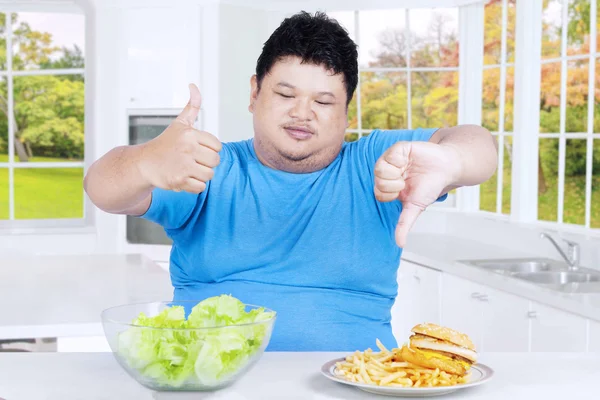Asian person with fresh salad and burger — Stock Photo, Image