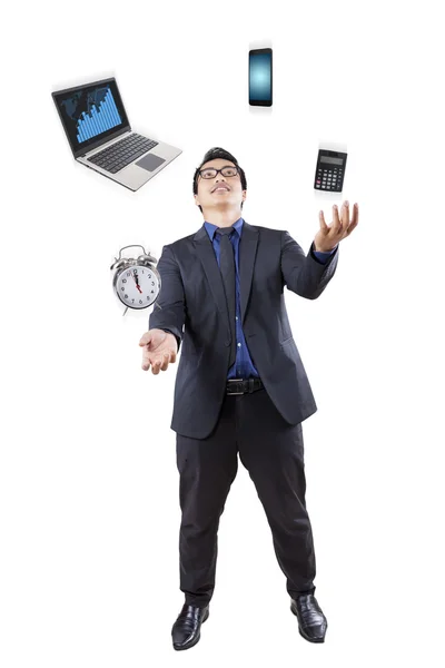 Businessman juggling with business items — Stock Photo, Image