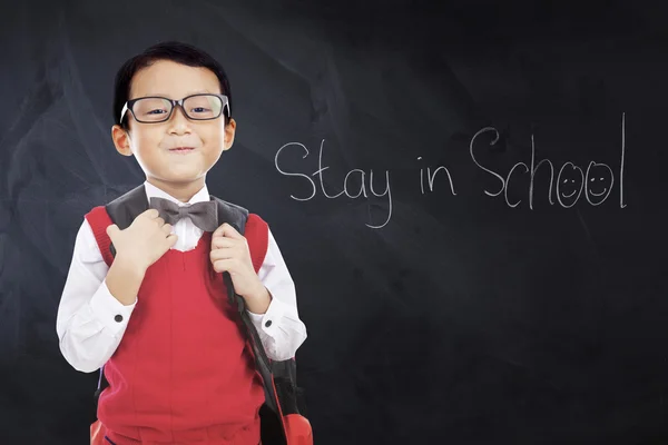 Child wears uniform with text Stay in School — Stock Photo, Image