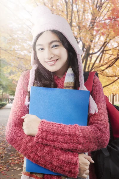 Cute student with sweater at autumn park — Stock Photo, Image
