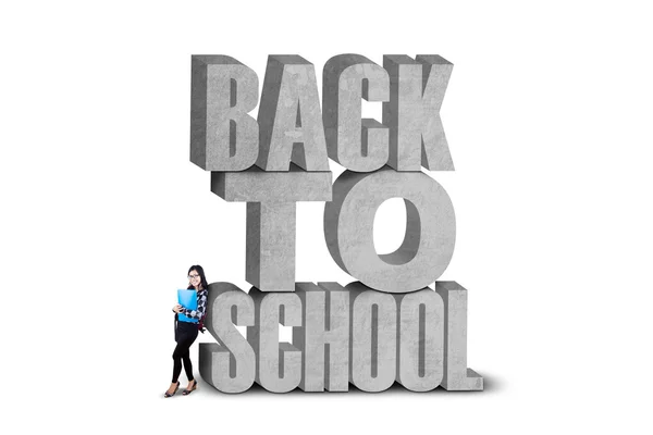 Female learner and a text of back to school — Stock Photo, Image