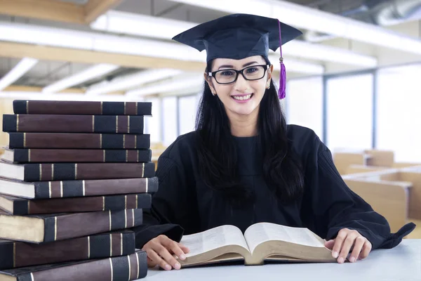 Smart bachelor in library — Stock Photo, Image