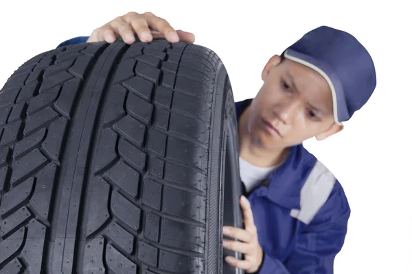 Tyre and male mechanic — Stock Photo, Image