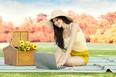 Kadın Park'ta dizüstü bilgisayar ile enterne browsing