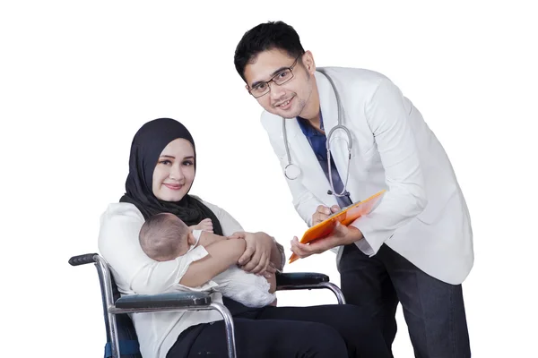 Disabled mother and doctor look at camera — Stock Photo, Image