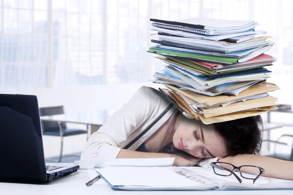 Exhausted woman sleeping on the table — Stock Photo, Image