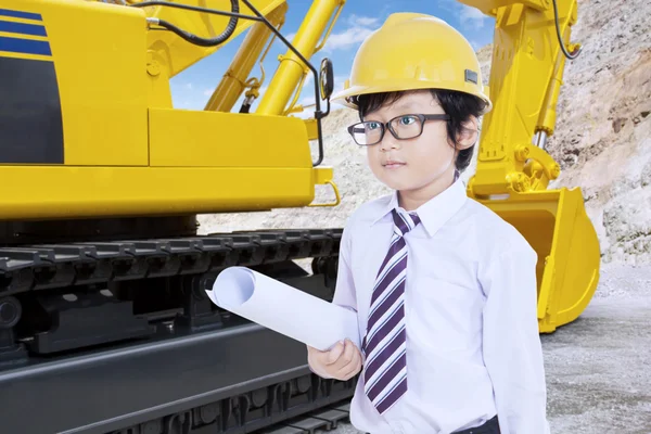 Little Architect with blueprint and excavator — Stock Photo, Image