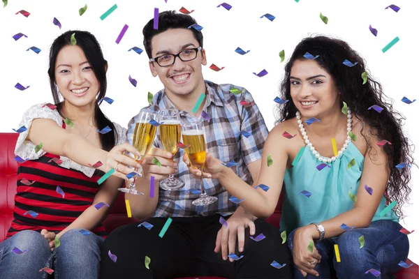 Three people toast with champagne glasses — Stock Photo, Image