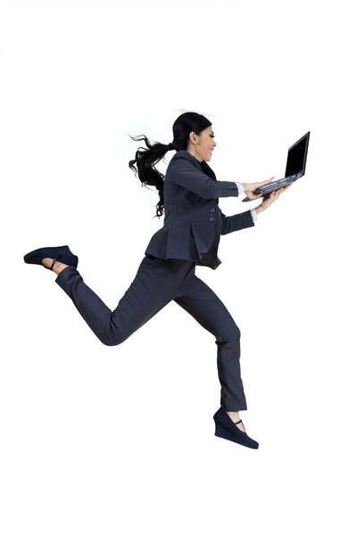 Woman working with laptop while running