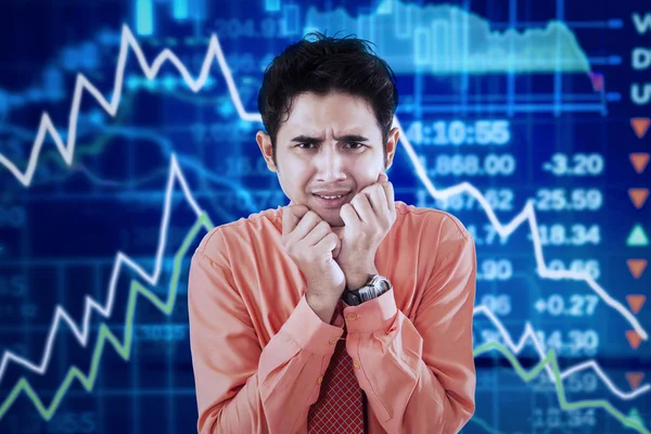 Stressed man and declining chart — Stock Photo, Image
