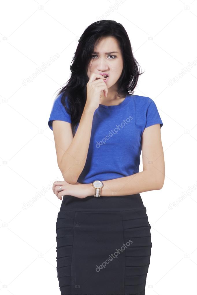 Frightened businesswoman biting her nail