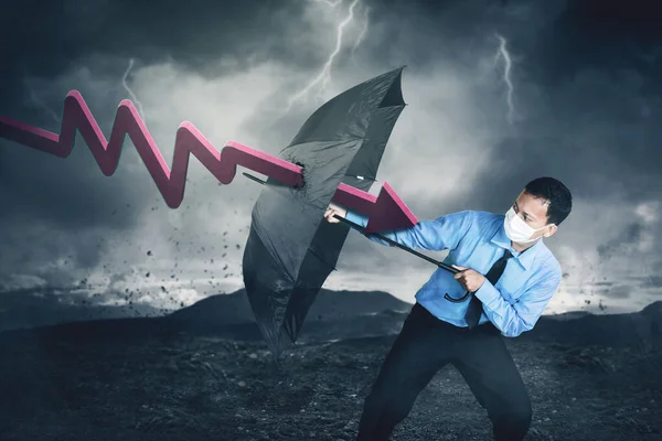 Young Businessman Attacked Declining Arrow While Holding Umbrella Stormy Sky — Stock Photo, Image