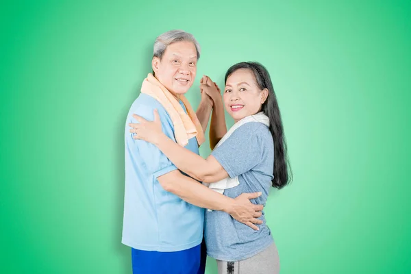 Senior Couple Wearing Sportswear Smiling Camera While Dancing Together Studio — Stock Photo, Image